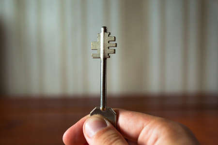 the keys to the apartment door in the man's hand