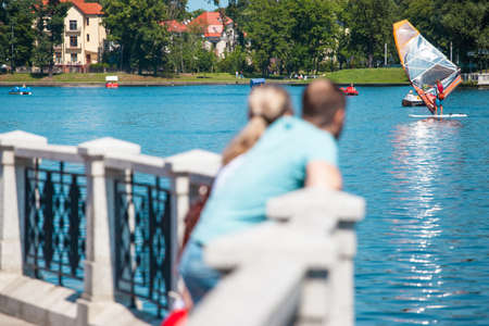 a man with a woman watching a windsurfingのeditorial素材