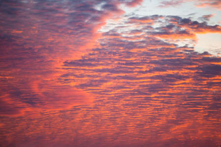 view of a bright orange sunset with clouds