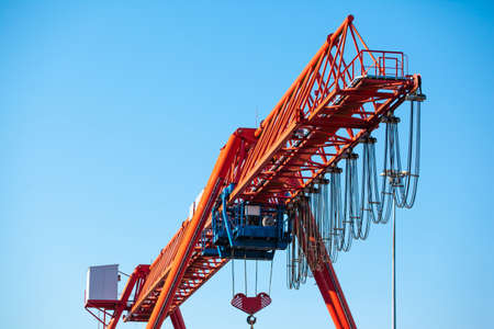 large industrial cargo crane against a blue skyのeditorial素材