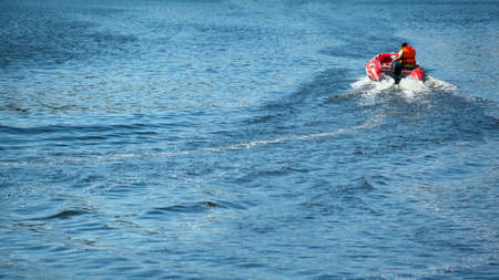 man in life jacket in inflatable boatのeditorial素材
