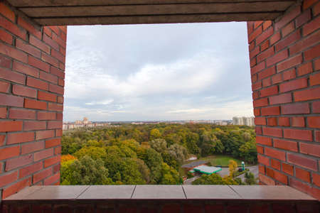 view from the window on top of the city with many treesのeditorial素材
