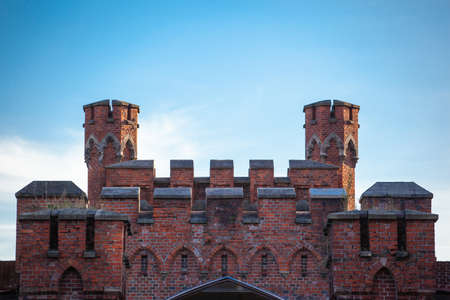 well-preserved towers of the old medieval castle of red brick against a blue skyのeditorial素材