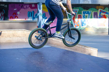 young athlete makes an extreme bike jump on a ramp