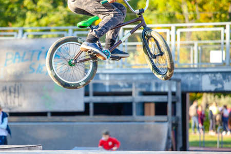 young athlete makes an extreme bike jump on a ramp