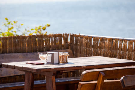 wooden restaurant table by the seaの写真素材