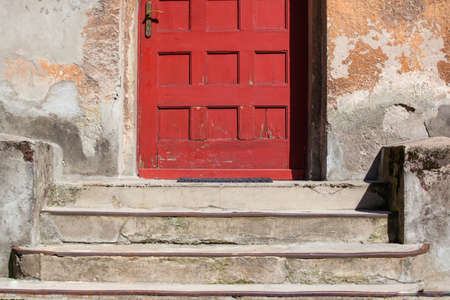 red front door in the old buildingの写真素材