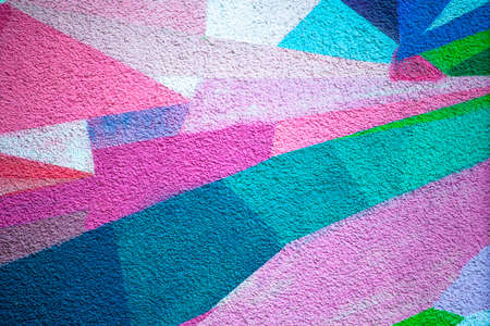 plastered bright wall, decorated with geometric patterns in different colors, background, textureの写真素材