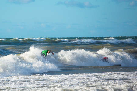 surfer rides on small wavesの写真素材