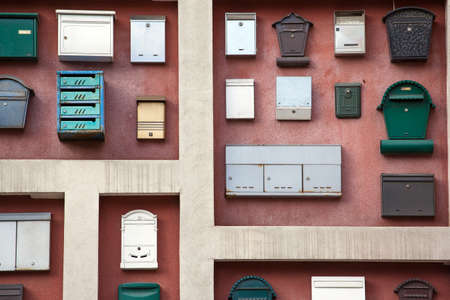 The wall of the house, decorated with a lot of mailboxes