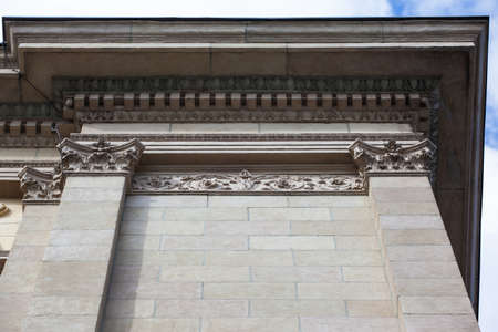 part of the classical faÃ§ade of a beige historical building with a relief