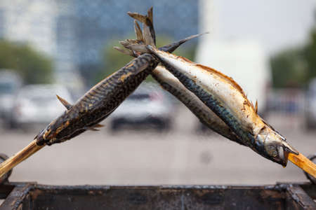 special preparation of fried golden and appetizing fish on a stick