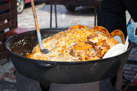 cooking pilaf in a huge cauldronの写真素材