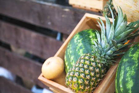 pineapple, watermelon and melon in boxes