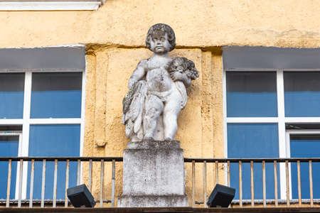decorations on the facade in the form of a boy's sculptureの写真素材