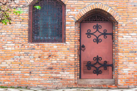 beautiful old door in a stone wallの写真素材