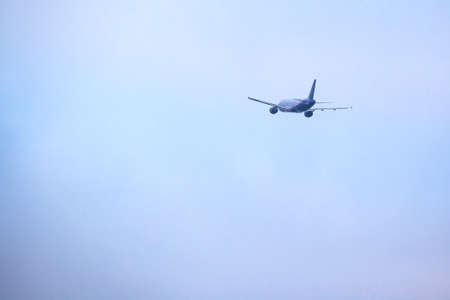 back view of a departing passenger liner against a blue sky