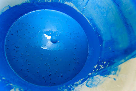 bright dark blue paint in a bucketの写真素材