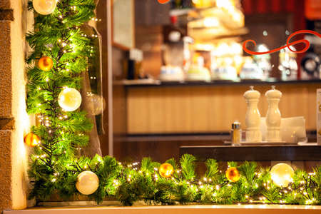 window decorated with fir branches with Christmas toys and garlandsの写真素材
