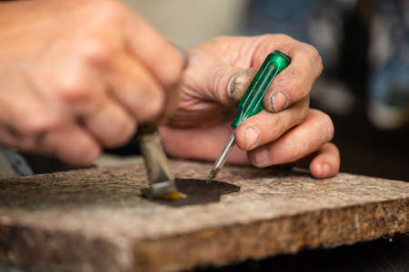 close-up of a male shoemaker's shoe glueing the sole of a shoe