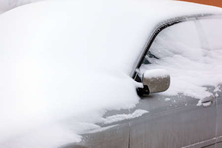 heavily snow covered carの写真素材