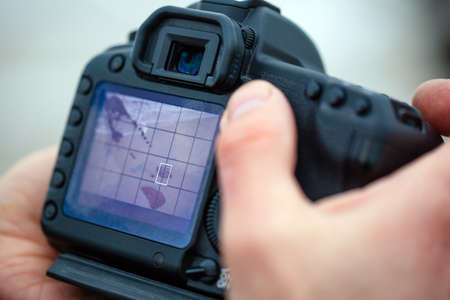 large professional camera in the hands of the photographer close up