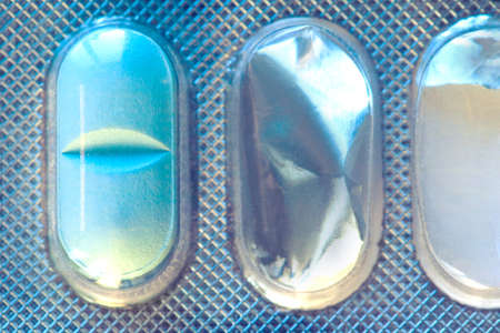 blue pill in the started packaging, macro, toned