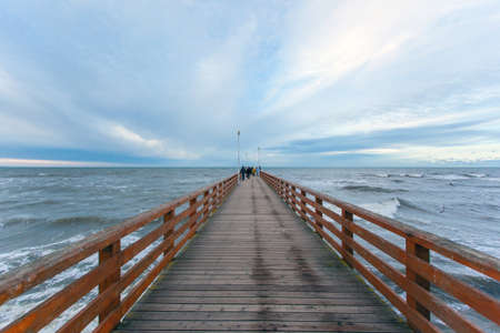 wooden pier extending into the distance by the seaの写真素材