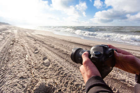 large professional camera in the hands of the photographer close upの写真素材