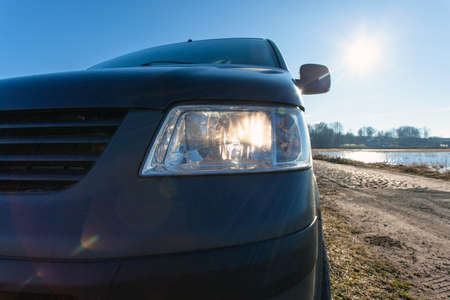 close-up of black car glowing front headlight