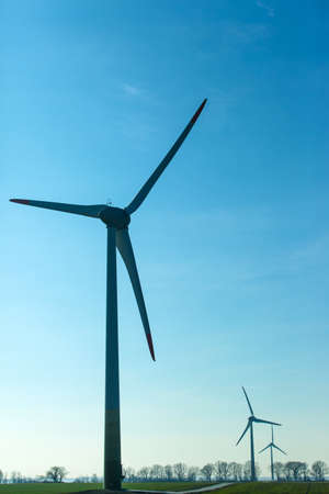 wind generators in a field on a clear sunny day