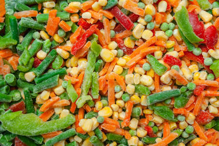 a mixture of frozen vegetables: corn, peas, carrots and paprika, background, textureの写真素材