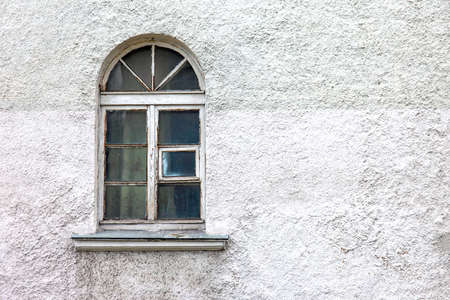 antique arched window in the wall