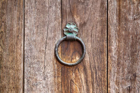 wooden surface with old door knocker