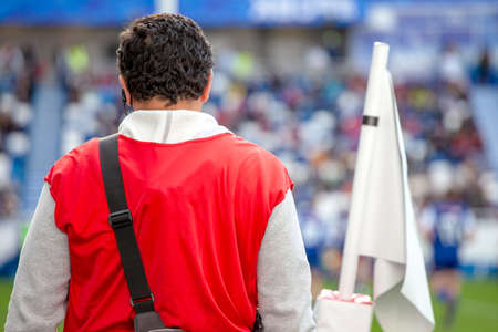 sports medic from the edge of the field watching the game