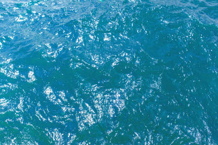 bright blue surface of ocean water, background, texture