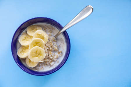 oatmeal with banana in a blue plate on a blue background