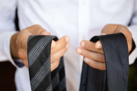 close-up of two neckties in the hands of a manの写真素材