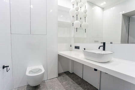 bright bright bathroom with a large washbasin mirrorの写真素材