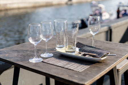 empty glasses on a table in a street restaurantの写真素材