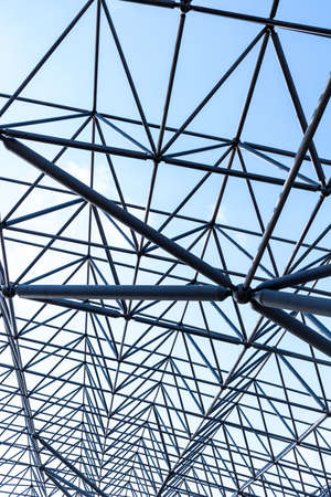 metal frame beams of modern building on sky backgroundの写真素材