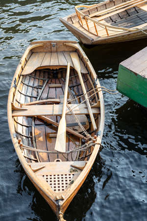 wooden boat with oars at the pier