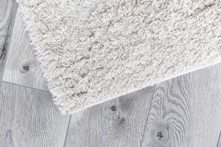 white home carpet on parquet floorの写真素材
