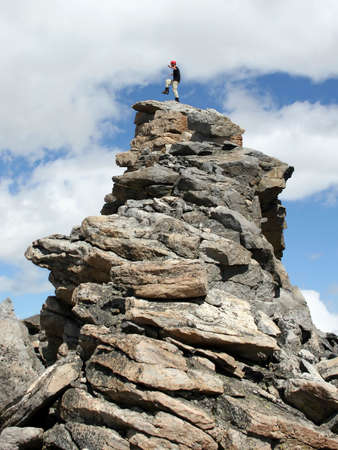 Alpine climber on a rock spire on Mount Lockhart, Montana.