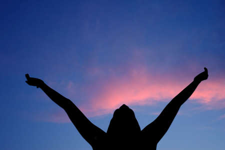 Female silhouette experiencing summer's pleasureの写真素材