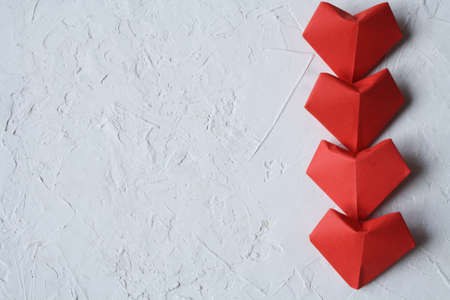 Red hearts on a textured white white background. Valentine day.の写真素材