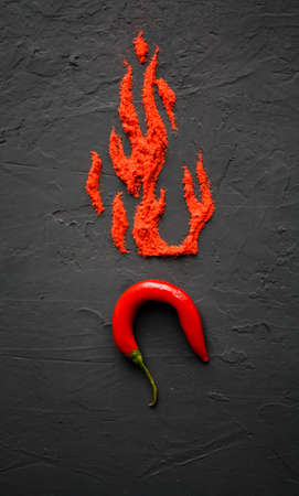 Red hot capsicum with paprika scattered in the form of flame petals