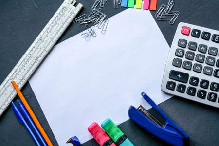 Stationery is placed around a white A4 sheet of paper .の写真素材