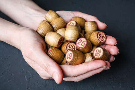 Lotto game. A woman holds a Lotto barrel against a black background.の写真素材