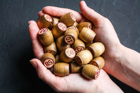 Lotto game. A woman holds a Lotto barrel against a black background.の写真素材